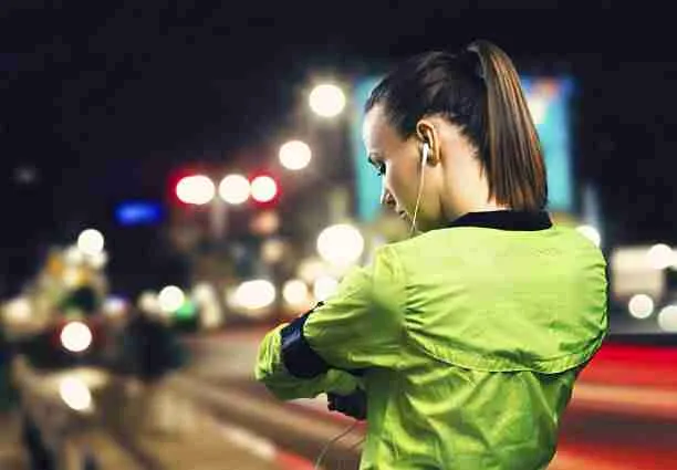 Young woman jogging at night in the city